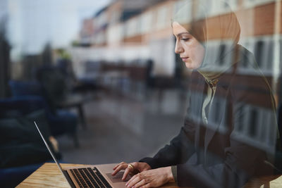 Woman in cafe using laptop