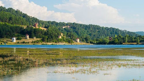 Scenic view of lake against cloudy sky