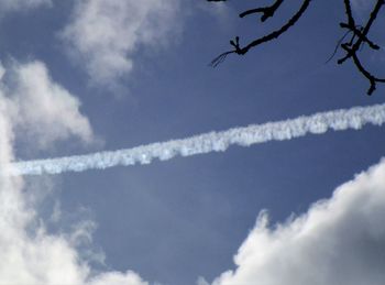 Low angle view of airplane flying against sky