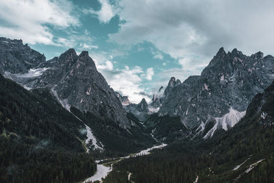 Scenic view of mountains against cloudy sky