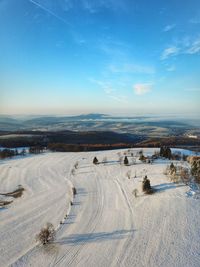 Tire tracks on snow covered landscape