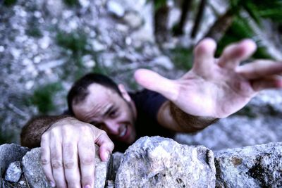 High angle view of man climbing wall