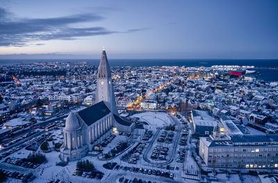 Drone view of majestic church in dusky city