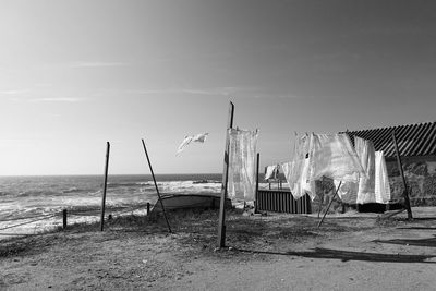 People at beach against sky