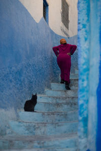 Rear view of people walking on snow covered mountain