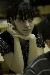 Teenage girl sitting at school