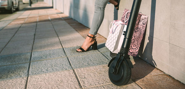 Low section of woman walking on footpath