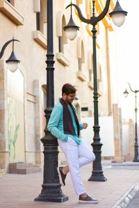 Full length of man looking at building in city