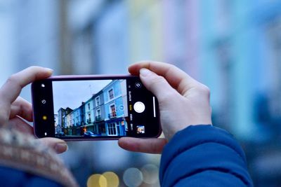 Midsection of man using mobile phone