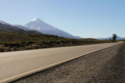 Surface level of country road against clear sky