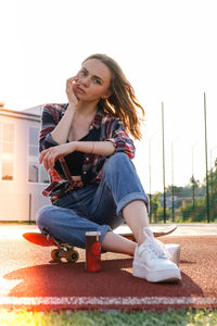 Portrait of smiling young woman sitting outdoors