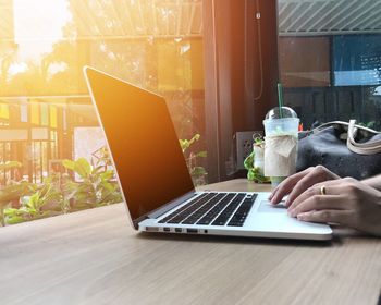 Woman using laptop on table at home