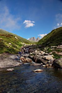 Rocks by sea against sky