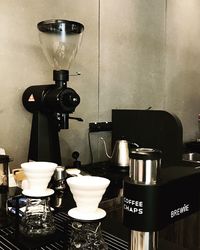 Close-up of coffee served on table against wall