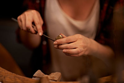 Midsection of woman painting on table