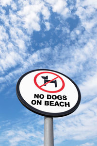 Low angle view of road sign against sky