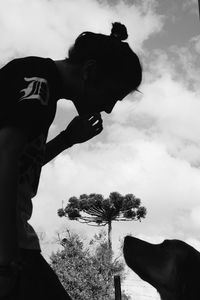 Low angle view of photographer photographing against sky