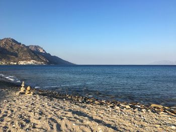 Scenic view of sea against clear blue sky