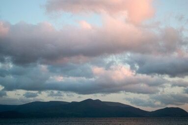 Scenic view of mountains against cloudy sky