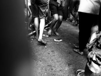 Low section of people walking on street