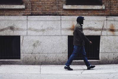 Man walking in front of building