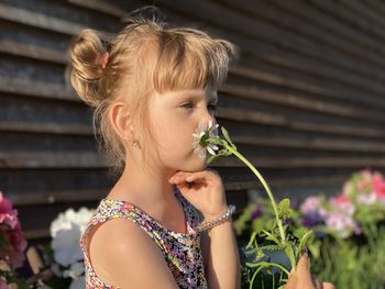 Portrait of woman holding flowering plant