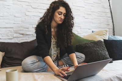 Young woman is working at home on the computer during the restrictions due to the covid-19 pandemic