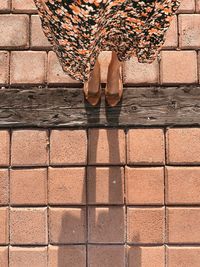 Low section of woman standing on footpath