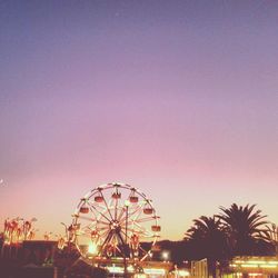 Low angle view of ferris wheel at night