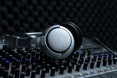 Close-up of headphones on sound mixer