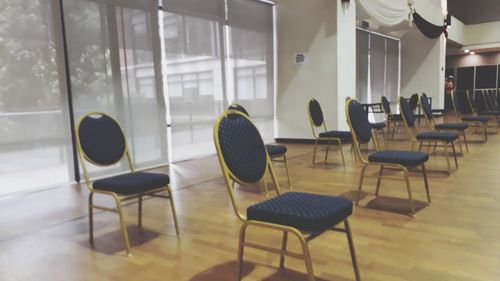 Empty chairs and table in room