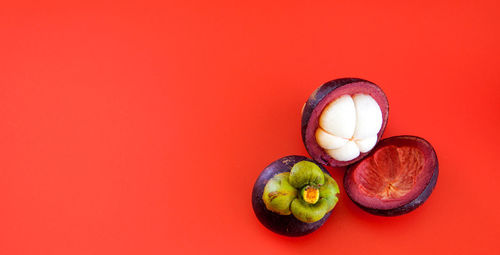 Close-up of apple against red background