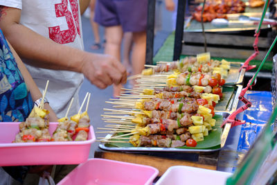 High angle view of people for sale at market stall