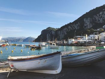 Boats moored on sea against sky