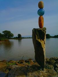 Cross on shore against sky