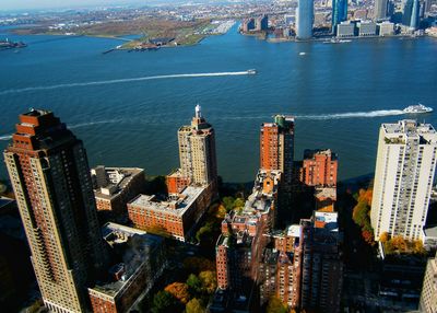 High angle view of buildings by river in city