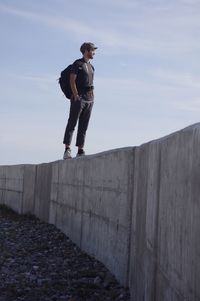 Low angle view of man standing on wall