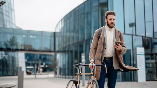 Low section of man using mobile phone