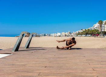 Sportsman practicing stretching and calisthenics