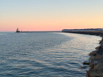 Scenic view of sea against clear sky during sunset