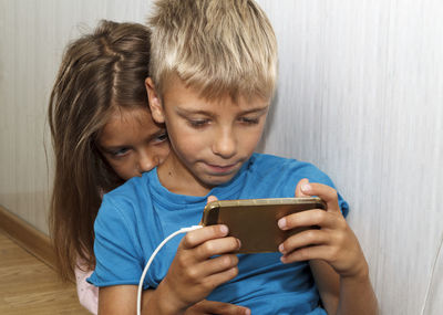 Close-up of a boy using mobile phone