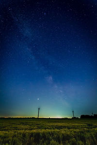 Scenic view of field against starry sky