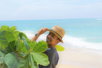 Portrait of man wearing hat against sky