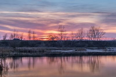 Scenic view of lake against sky at sunset