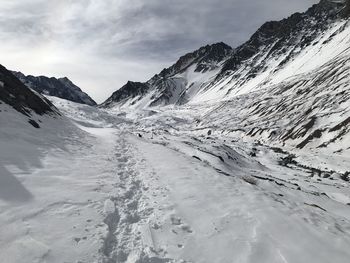 Scenic view of snow covered mountains against sky