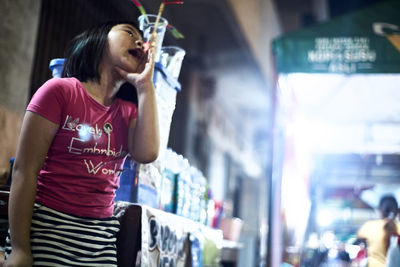 Low angle view of woman standing at music concert