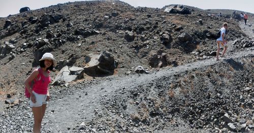 Side view of woman standing on rock