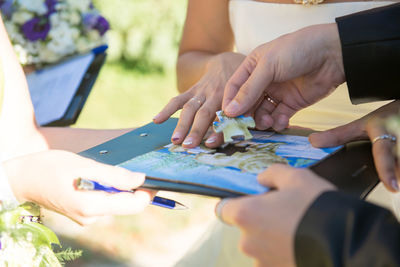 Cropped image of bride and groom playing puzzle