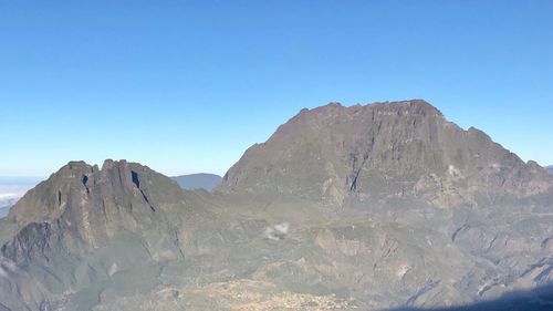 Scenic view of mountains against clear blue sky