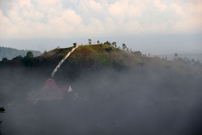 Panoramic view of people on land against sky